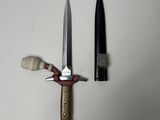 a knife and a bottle next to each other on a table