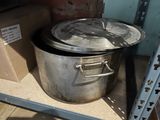 a large metal pot with a lid sitting on a shelf