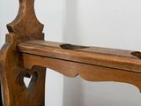 a wooden bench that has a wooden shelf on it