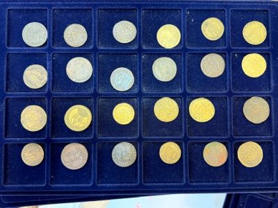a box of gold coins sitting on top of a table