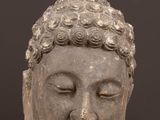 an image of a statue of a head on a wooden table