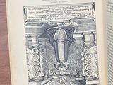 an open book with a picture of a statue on it