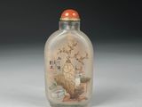 a glass snuff bottle with a painting on it