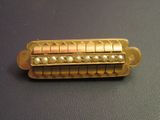 a gold pin with pearls on it sitting on a table