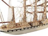 a model of a sailing ship on a white surface