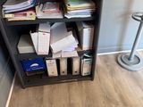 a book shelf with a bunch of papers on it