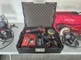 a box with tools on a table with a red bag