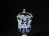 a blue and white vase sitting on top of a black surface