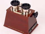 an image of a pair of binoculars on a wooden stand