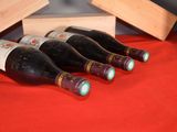 several bottles of wine are lined up on a red table