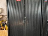two metal doors that are open in a room