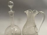 two glass vases sitting next to each other on a table