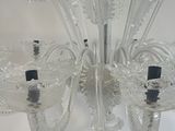 a clear glass chandelier hanging from a ceiling