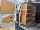 a white van with its door open in a parking lot
