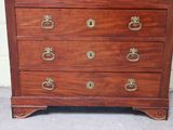 a wooden chest of drawers with brass handles on it