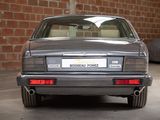 a silver car parked in a garage with a brick wall in the background