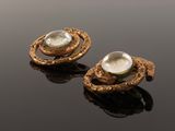 a pair of gold earrings with a faceted quartz stone