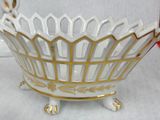 a white and gold bowl sitting on a table