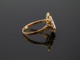 a close up of a gold ring with a diamond on a black surface