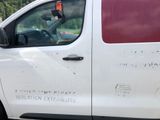 a white van with a red stripe parked on the side of the road