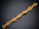 an image of a gold bracelet with a braid design