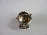 a small silver object that is on a white surface