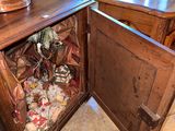 a wooden cabinet with a trash can inside of it