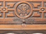 a wooden bench with carvings on the top of it
