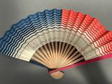 a fan that has a red, white, and blue design on it