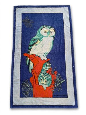 blue and white towel with a bird and a cat on it