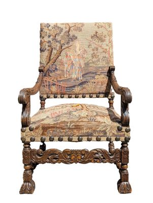 an old chair with a tapestry on the back of it