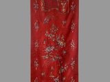 an oriental red wall hanging with a bird and flowers design