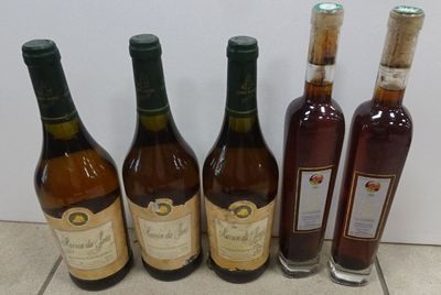 several bottles of wine are lined up on a tile floor