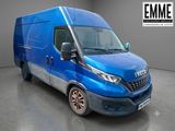 La camionnette bleue est garée dans une grande pièce.