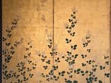 an image of a gold screen with green leaves on it