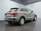 the rear end of a silver audi suv parked in a garage