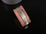 a close up of a wallet with a ring on top of it