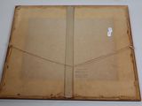 an old book is open on a table with a piece of paper on it