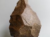 a large rock sitting on a clear stand on a white surface