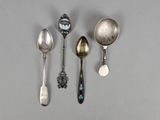 three silver spoons and a spoon with a clock on them