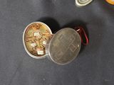 a small tin with a coin inside of it on a table