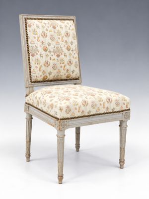 an upholstered chair with a floral upholstered seat