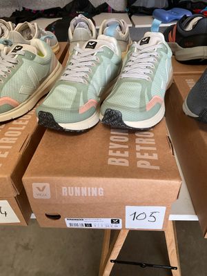 several pairs of running shoes are on a box on a table
