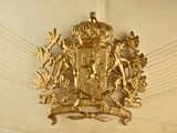 a gold hat with a coat of arms and a crown on it