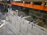 concrete blocks are stacked on pallets in a warehouse area