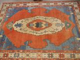 an orange and blue area rug with a design on it
