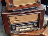 three old fashioned radio ' s stacked on top of each other