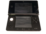 a black nintendo wii game system on a white surface