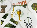 many plates with different designs on them on the wall