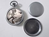 a silver pocket watch and a silver pocket watch on a white surface